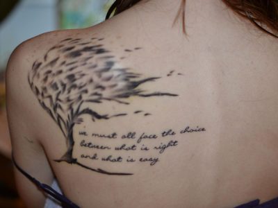 Tree and phrase tattoo on the back