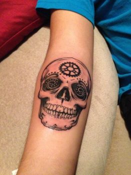 skull tattoo at forearm