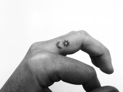 Small tattoo of the sun and the moon