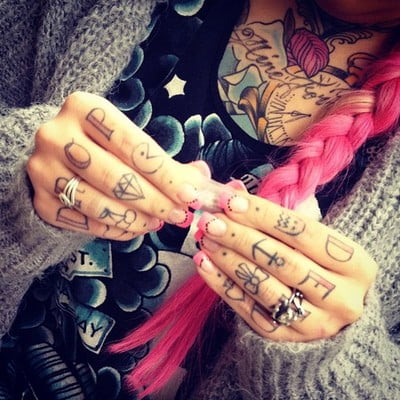 multiple tattoos on fingers