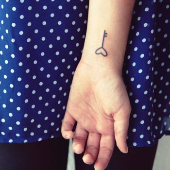 Small key tattoo on wrist