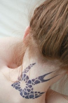 Bird tattoo on the neck