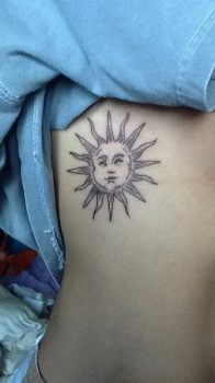 Sun tattoo on ribs